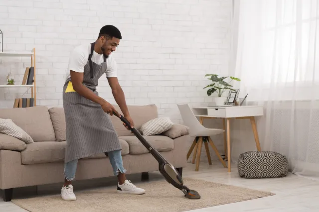 House cleaner vacuuming a modern living room